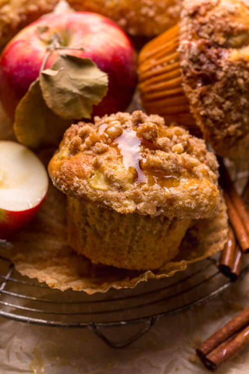 Apple muffins on a cooling rack with pink lady apples.